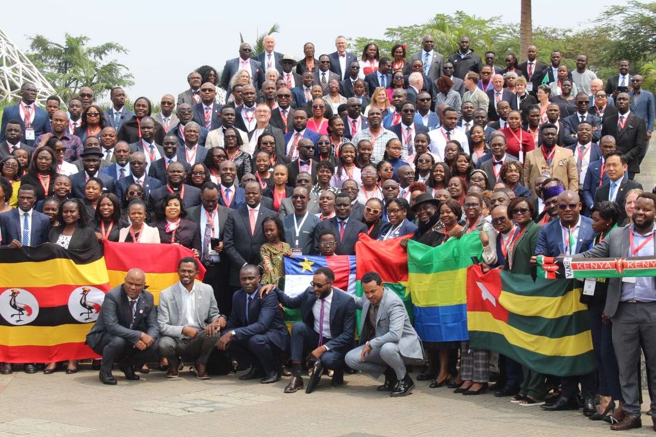 Advocates Africa participants gathered outdoors with African national flags